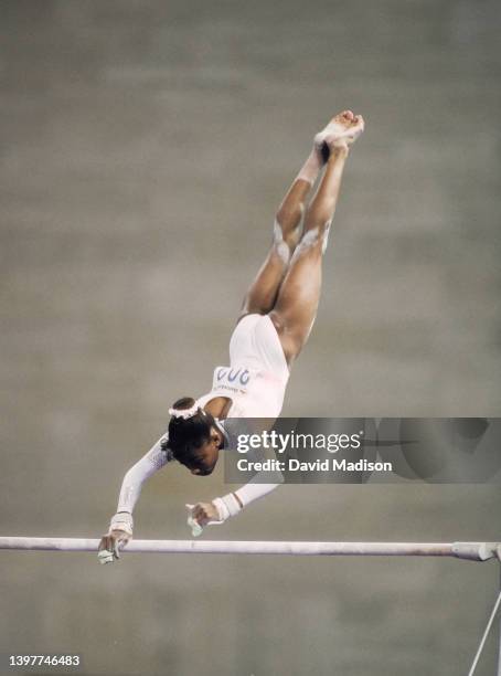 Dominique Dawes of the United States performs on the Uneven Bars on July 28, 1992 during the Team All-Around event of the Women's Gymnastics...