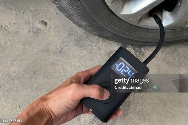 inflate tires with a micro air pump - luftpump bildbanksfoton och bilder