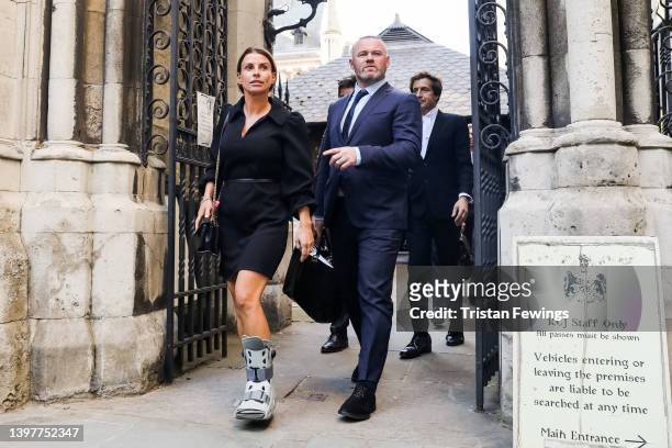 Coleen Rooney and Wayne Rooney leave the Royal Courts of Justice, Strand on May 17, 2022 in London, England. Coleen Rooney, wife Derby County manager...