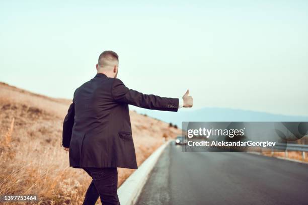 hitchhiking male late for his own wedding - hitchhiking stock pictures, royalty-free photos & images