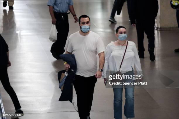 People wear masks inside a store on May 17, 2022 in New York City. New York’s health commissioner, Dr. Ashwin Vasan, has moved from a "medium"...