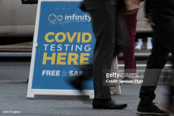 People walk past a Covid testing site on May 17, 2022 in New York City. New York’s health commissioner, Dr. Ashwin Vasan, has moved from a "medium"...