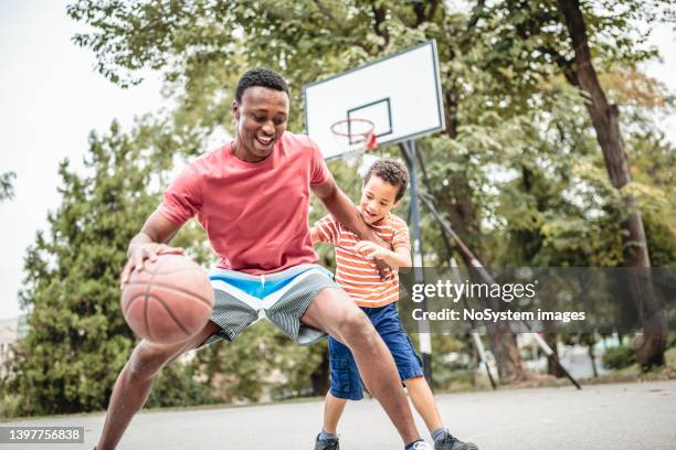 father and son playing basketball - basketball shot stock pictures, royalty-free photos & images