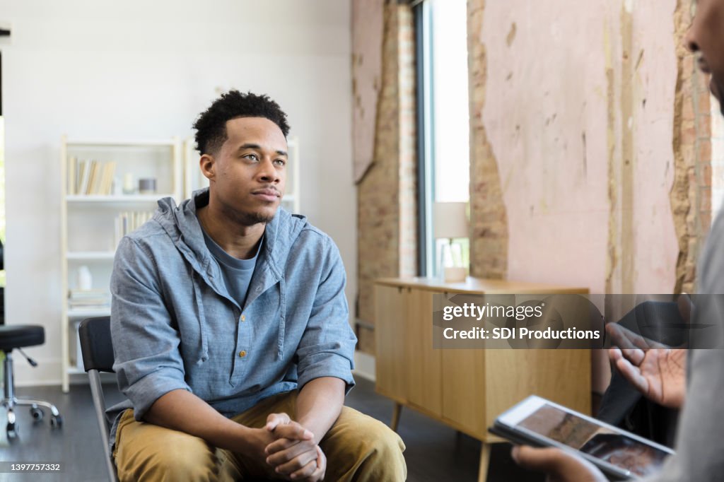 Young adult male listens to his therapist