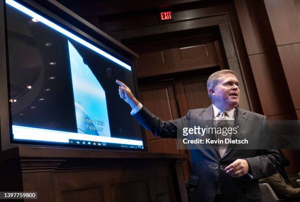 Deputy Director of Naval Intelligence Scott Bray explains a video of unidentified aerial phenomena, as he testifies before a House Intelligence...
