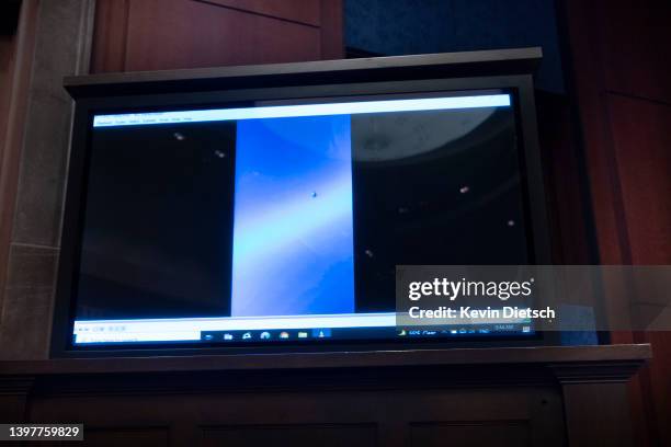 Video of unidentified aerial phenomena is played as U.S. Deputy Director of Naval Intelligence Scott Bray testifies before a House Intelligence...