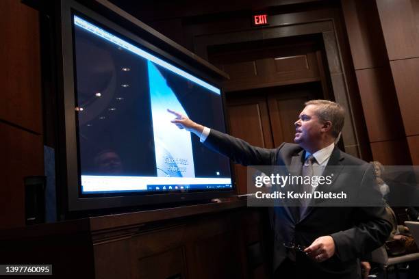 Deputy Director of Naval Intelligence Scott Bray explains a video of an unidentified aerial phenomena, as he testifies before a House Intelligence...