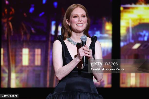 Julianne Moore speaks on stage during the opening ceremony for the 75th annual Cannes film festival at Palais des Festivals on May 17, 2022 in...