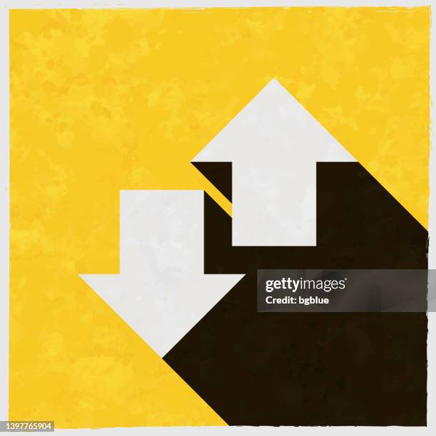 up and down transfer arrows. icon with long shadow on textured yellow background - decal stock illustrations