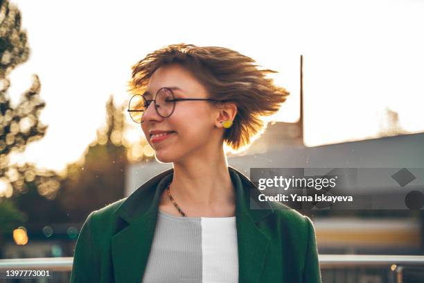 beautiful feminine woman in glasses is enjoying the sunset - white blonde hair stock pictures, royalty-free photos & images