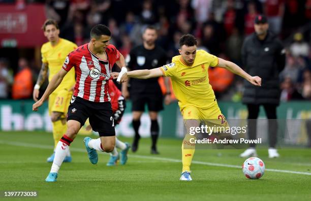 Diogo Jota of Liverpool competing with Mohamed Elyounoussi of Southampton during the Premier League match between Southampton and Liverpool at St...