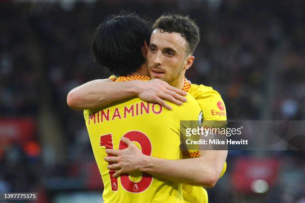 Takumi Minamino of Liverpool celebrates with team mate Diogo Jota after scoring their sides first goal during the Premier League match between...