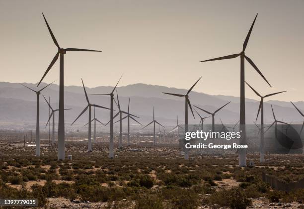 An array of electricity producing wind turbines are viewed along Interstate 10 on May 11, 2022 near Palm Springs, California. The Coachella Valley,...