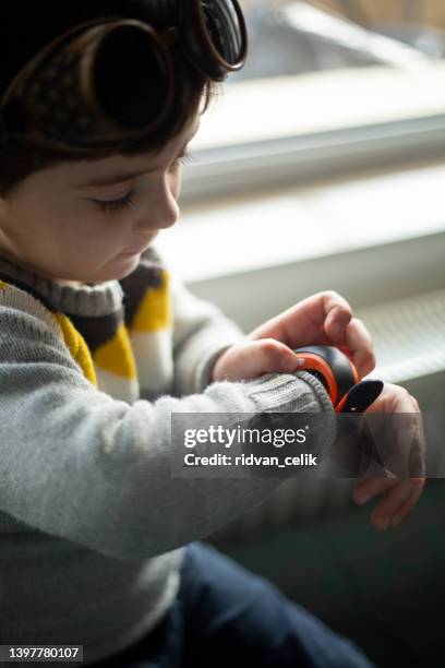 boy looks at information on digital clock pressing screen with his index finger. - turkey hunting 個照片及圖片檔