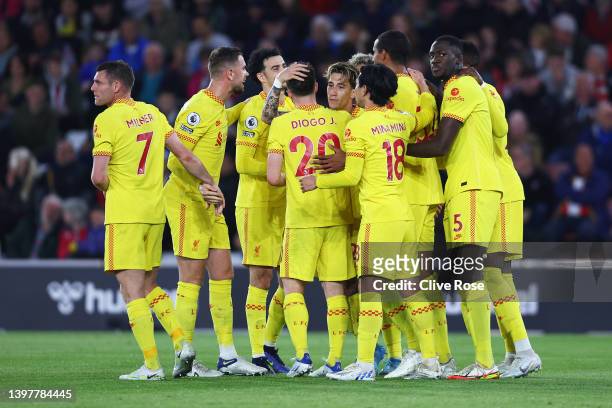 Joel Matip of Liverpool celebrates with team mates after scoring their sides second goal during the Premier League match between Southampton and...