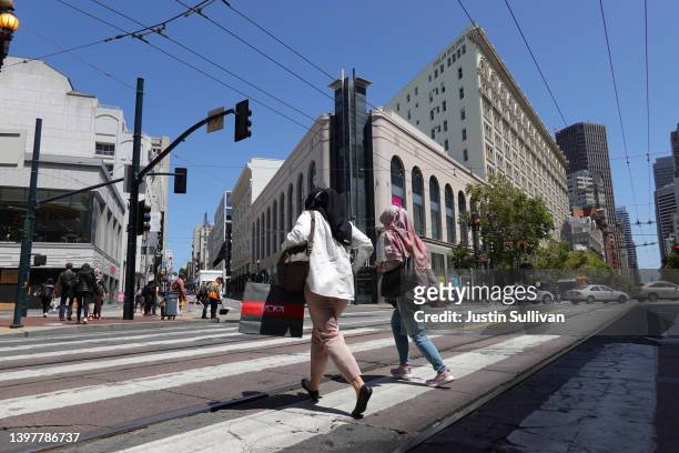 Pedestrian carries a shopping bagwhile walking through Union Square on May 17, 2022 in San Francisco, California. Monthly retail sales were up 0.9...