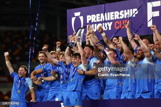 Ted Hill of Worcester Warriors lifts the Premiership Rugby Cup as their team mates celebrate after victory in the Premiership Rugby Cup Final between...