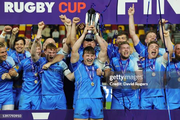 Ted Hill of Worcester Warriors lifts the Premiership Rugby Cup as their team mates celebrate after victory in the Premiership Rugby Cup Final between...
