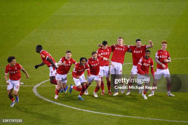 The Notts Forest team celebrate winning the penalty shoot out during the Sky Bet Championship Play-Off Semi Final 1st Leg match between Nottingham...