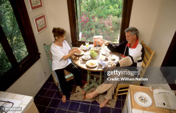 American actor and television host Jed Allan and his wife Toby have breakfast at their home circa July, 1991 in Los Angeles, California.