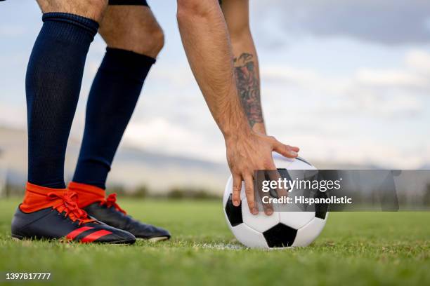 soccer player arranging the ball on the field - corner kick stock pictures, royalty-free photos & images