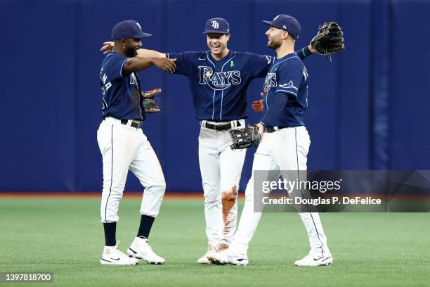 Randy Arozarena, Brett Phillips and Kevin Kiermaier of the Tampa Bay Rays celebrate after an 8-1 win over the Detroit Tigers at Tropicana Field on...