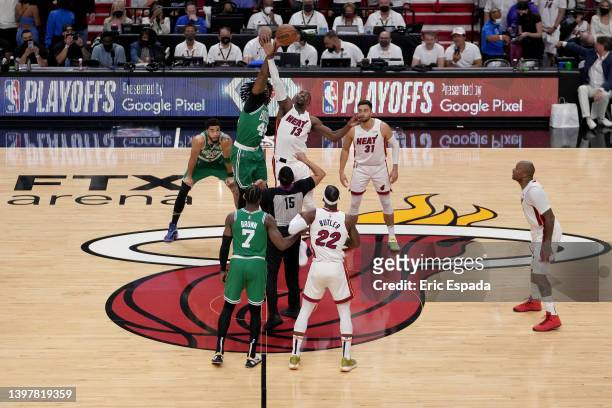 Robert Williams III of the Boston Celtics jumps for the ball against Bam Adebayo of the Miami Heat during the first quarter in Game One of the 2022...