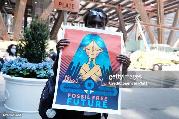 Youth climate activist joins others at a demonstration outside the building where JPMorgan Chase was holding their annual shareholders meeting on May...