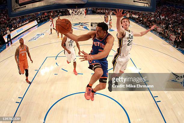 Landry Fields of the New York Knicks and Team Shaq drives for a shot attempt against Gordon Hayward of the Utah Jazz and Team Chuck during the BBVA...
