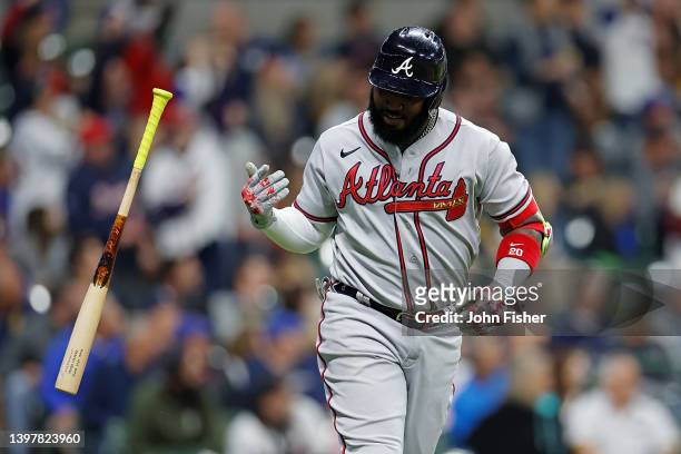 Marcell Ozuna of the Atlanta Braves flips his bat after hitting a two run homer in the eighth inning against the Milwaukee Brewers at American Family...