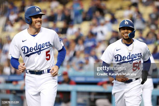 Freddie Freeman and Mookie Betts of the Los Angeles Dodgers react after scoring on a two-run single off the bat of Trea Turner during the first...