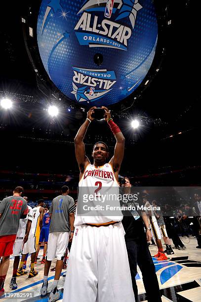 Kyrie Irving hoists his MVP trophy after the BBVA Rising Stars Challenge as part of 2012 All-Star Weekend at the Amway Center on February 24, 2012 in...