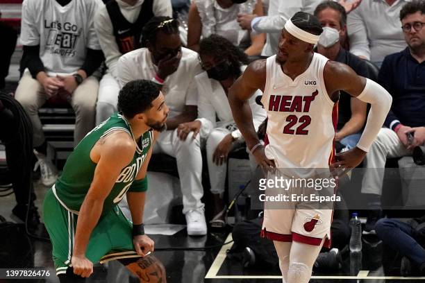 Jimmy Butler of the Miami Heat talks with Jayson Tatum of the Boston Celtics during the third quarter in Game One of the 2022 NBA Playoffs Eastern...