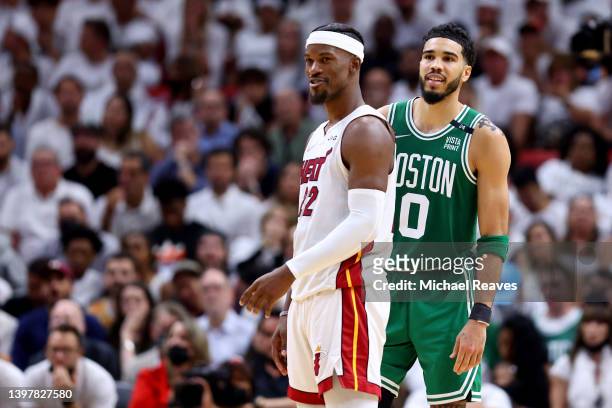 Jimmy Butler of the Miami Heat and Jayson Tatum of the Boston Celtics look on during the fourth quarter in Game One of the 2022 NBA Playoffs Eastern...