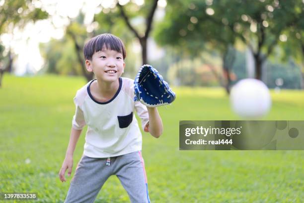 young boy playing baseball - playing catch stock pictures, royalty-free photos & images