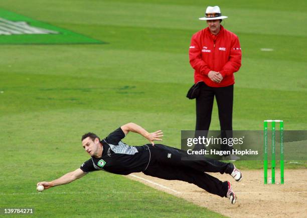 Nathan McCullum of New Zealand fields a ball off his own bowling during the One Day International match between New Zealand and South Africa at...