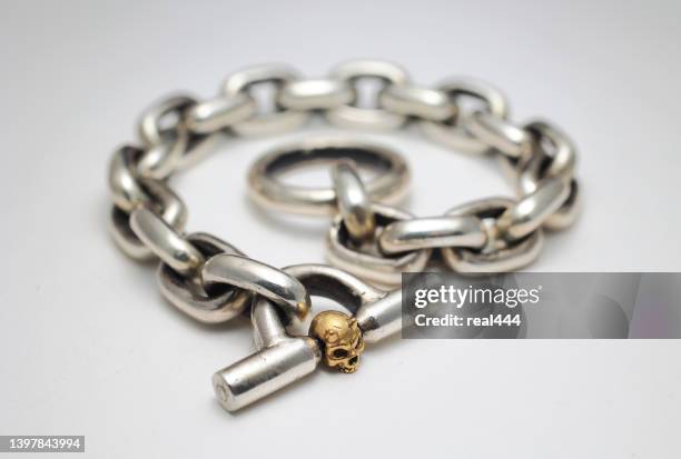 skull  bracelet with chains - silver bracelet stock pictures, royalty-free photos & images