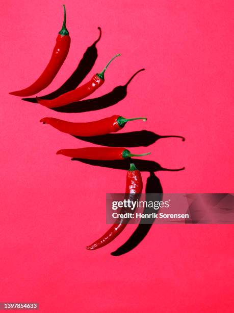 red chilli pepper - seasoning mid air stock pictures, royalty-free photos & images