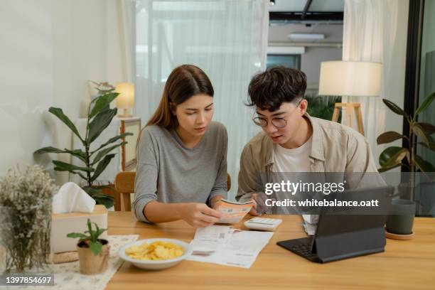 pareja haciendo finanzas del hogar juntos en casa. - monthly event fotografías e imágenes de stock