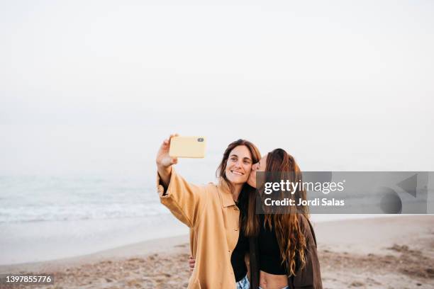 two women at the beach - gay love stock pictures, royalty-free photos & images