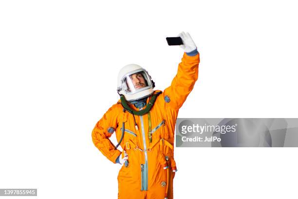 young man in space suit making selfie - astronaut hand stock pictures, royalty-free photos & images