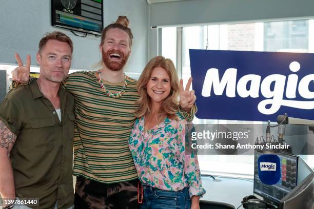 Sam Ryder poses with Ronan Keating and Harriet Scott as he visits Magic Radio on May 18, 2022 in London, England.