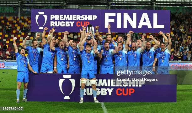 Ted Hill, the Worcester Warriors captain, raises the trophy as they celebrate after their victory during the Premiership Rugby Cup Final between...