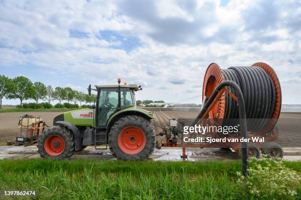 Irrigation pivot gun machine spraying water on a field during a dry and warm spring day on May 17, 2022 in Nagele, The Netherlands. Over the last...