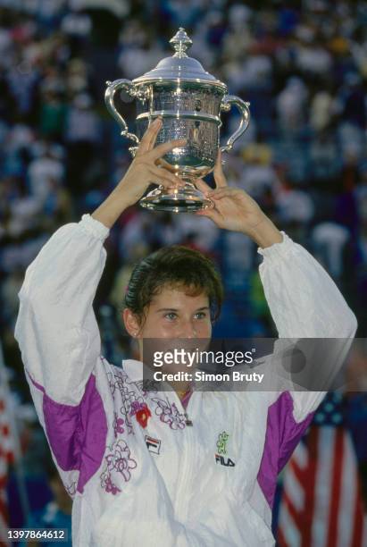 Monica Seles from Yugoslavia holds the trophy aloft to clebrate winning the Women's Singles Final match of the US Open Tennis Championship against...
