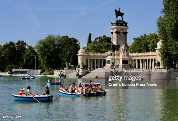 Several people enjoy the boats in El Retiro on a day when Spain has begun to suffer an "important" warm episode with midsummer temperatures on May 17...