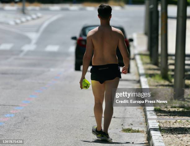 Man walks shirtless on the day that Spain has begun to experience a "major" hot spell with midsummer temperatures on May 17 in Madrid, Spain. Some...