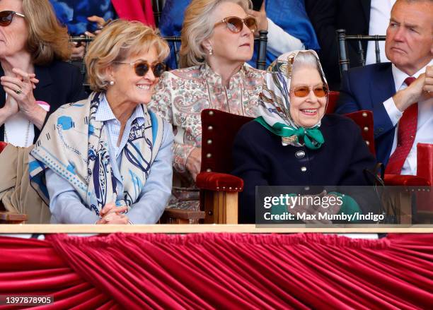 Queen Elizabeth II, accompanied by Penelope Knatchbull, Countess Mountbatten of Burma, watches her horse 'Balmoral Leia' win the 'Horse & Hound...