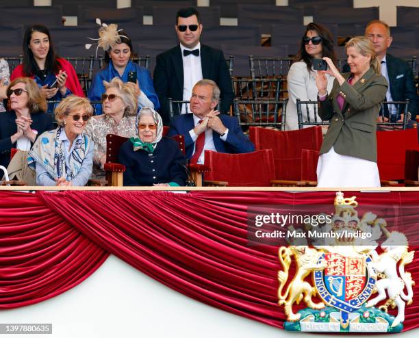 Queen Elizabeth II, accompanied by Penelope Knatchbull, Countess Mountbatten of Burma and Sophie, Countess of Wessex , watches her horse 'Balmoral...