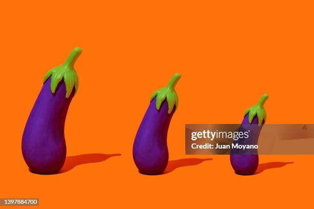 three fake eggplant of different sizes - aubergine stock pictures, royalty-free photos & images